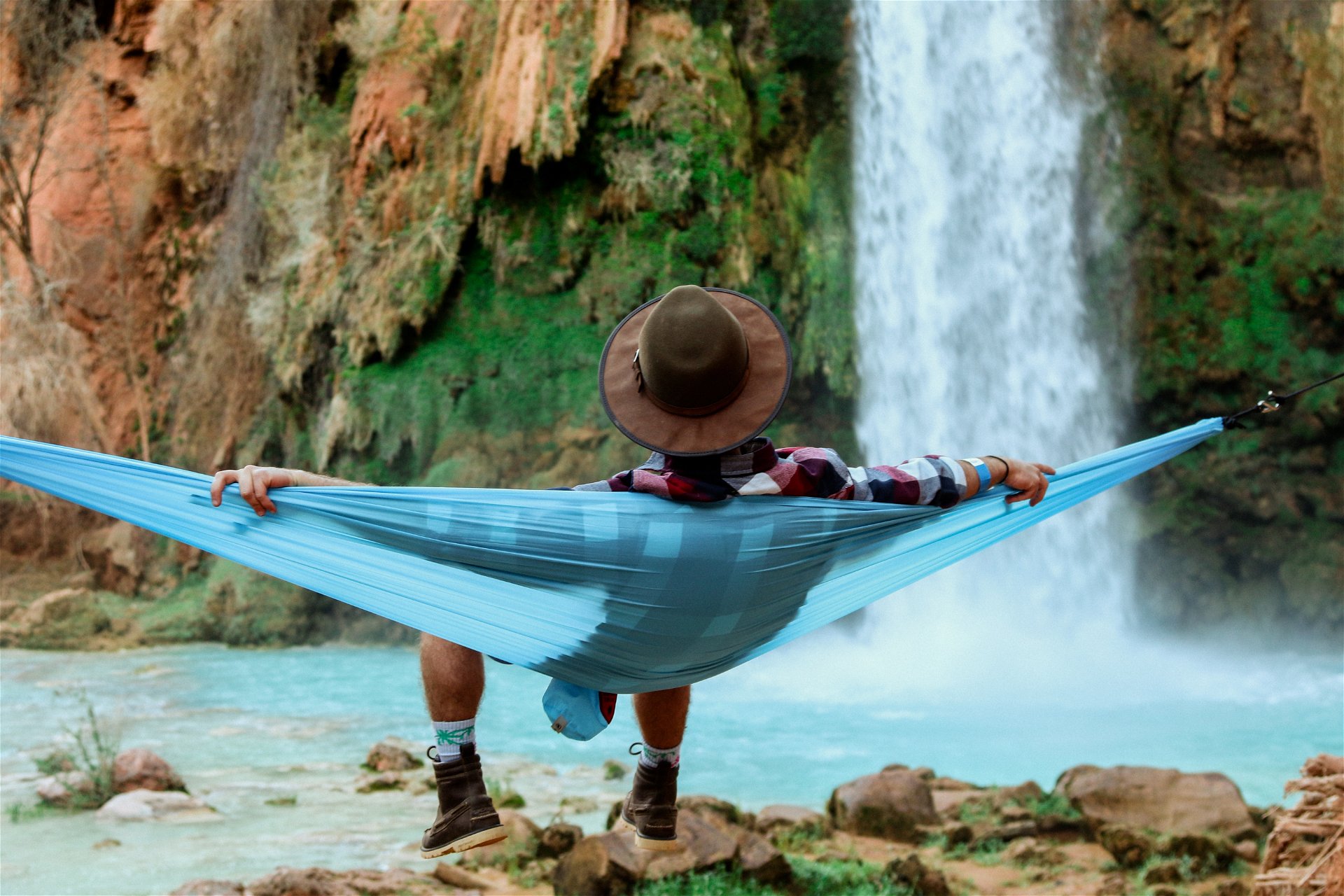 retired-man-on-hammock-by-a-waterfall